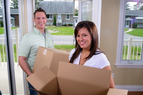 Removal team reviewing a customer complaint during a house move
