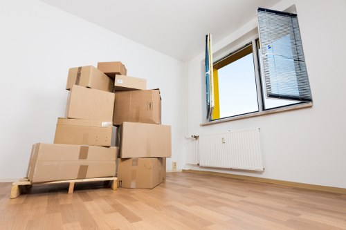 Professional removals crew working carefully with safety measures in place