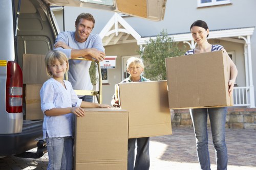 Office equipment, boxes, and furniture arranged for a Scottish business move