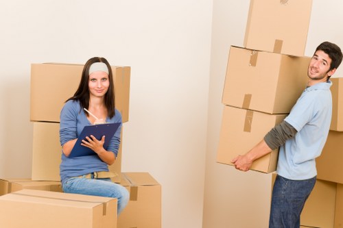 Packed moving boxes and furniture being loaded for transport